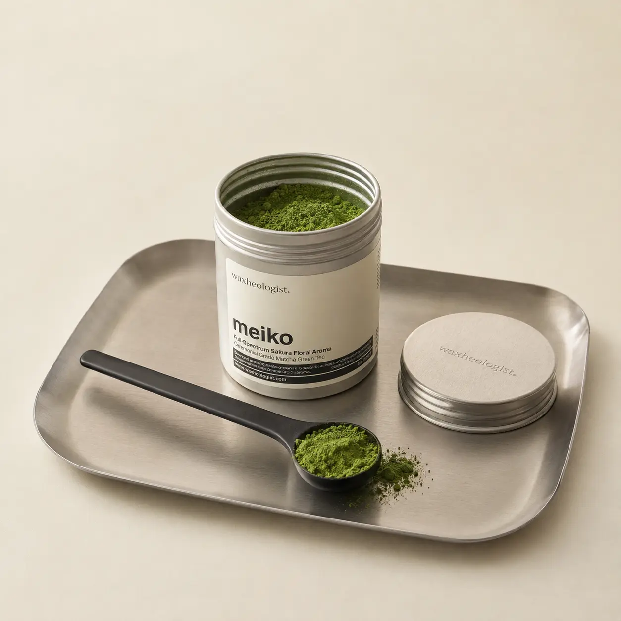 Meiko matcha tin and green powder styled as a refined studio product set