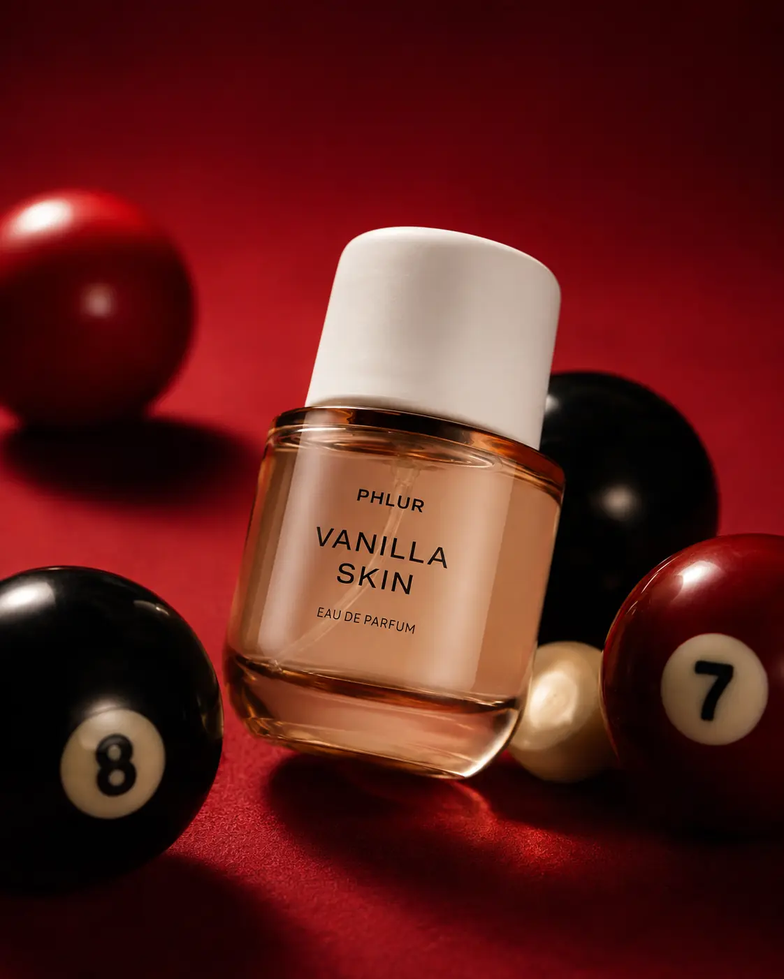 Fragrance bottle staged on a red billiards table