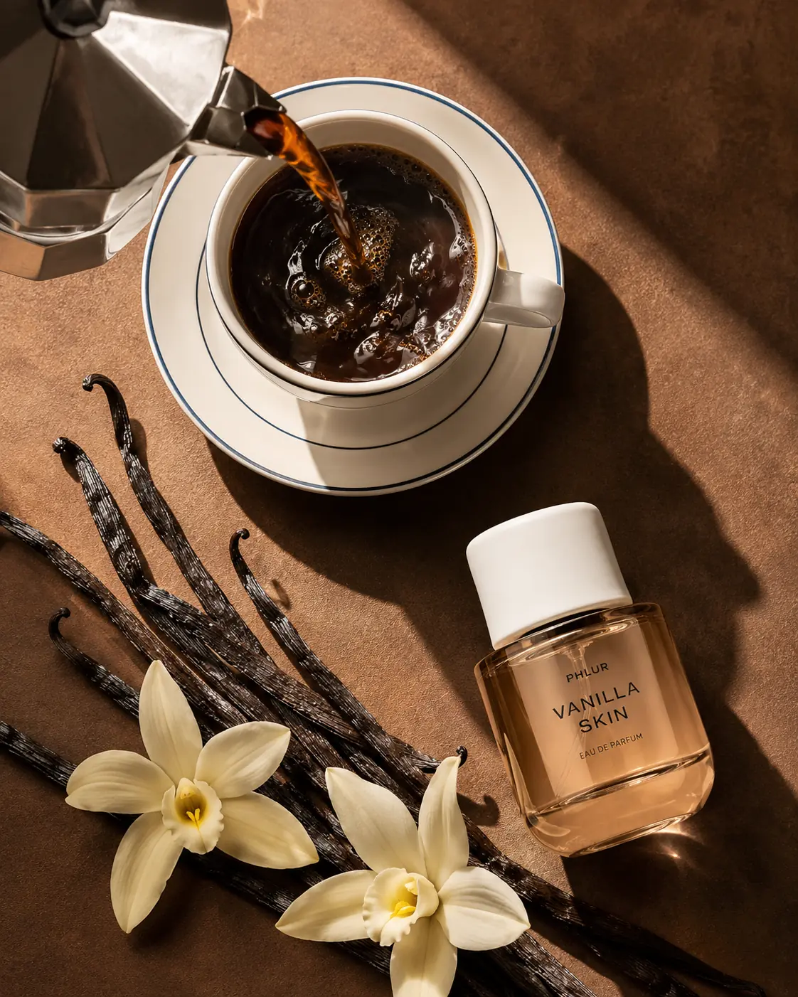 Fragrance bottle, vanilla and coffee arranged in a top-down still life